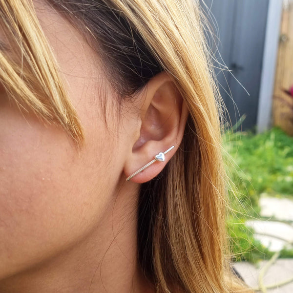 Heart line ear climber: Heart Suspender Earring | Dana Mantzur